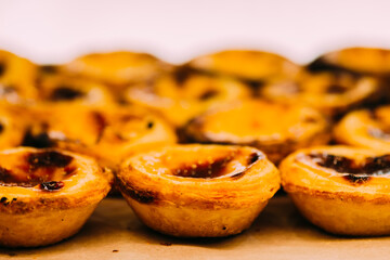 Stack of Portuguese egg tart also known as Pasteis de Nata on display in front of shop