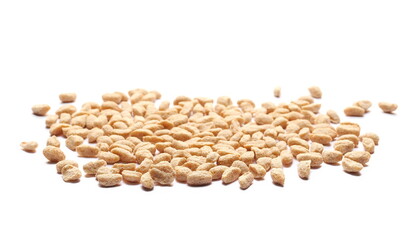 Extruded crunchy oat flakes, pile isolated on white