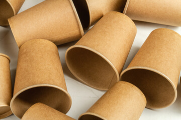 Many brown disposable empty paper cups. Containers for beverage.