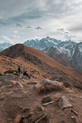 Mountains landscape with some people hiking. Sunset or sunrise in mountains. 