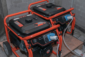 Powerful electric generators work in the garage. Two gasoline generators generate electricity...