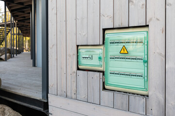 Plastic electric board on the side wall of building - control panel with electrical fuseboxes and...