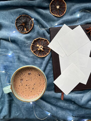 Cup of coffee and notebook with white paper 