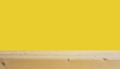 selective focus.Empty of wood table top on yellow pastel color background.