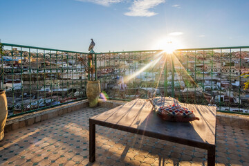 Pigeon resting on rooftop terrace in Medina during sunset, Fez, Morocco