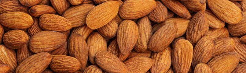 Peeled almonds background closeup. Vegetarian food concept. Raw almond nuts wallpaper.