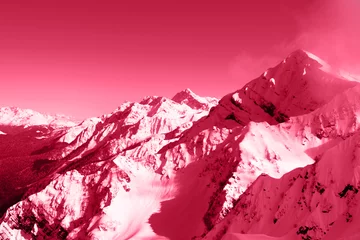 Snow-capped mountain peaks. Natural background. Ski resort mountains nature and sports. Beautiful viva magenta color background.