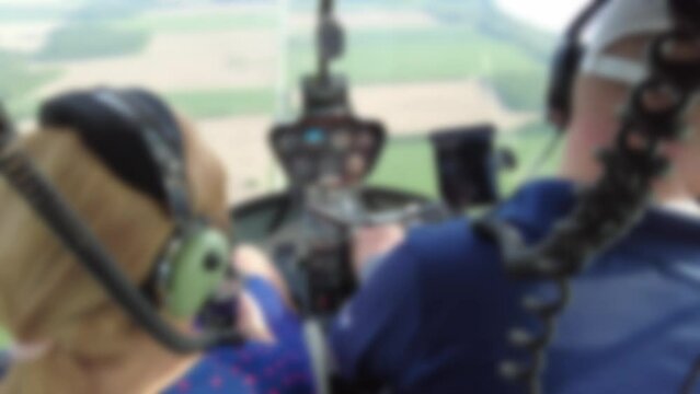 Blurred 002 Woman Enjoying Private Helicopter Tour As Pilot Flies Helicopter Over Land