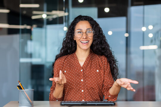 Online Customer Support Video Call, Latin American Woman Looking At Web Camera Smiling And Consulting Customers, Helpline Worker Working Inside Office.