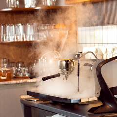 Professional coffee machine at restaurant, steam in coffee shop
