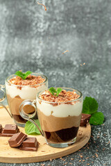 dessert three chocolates with mint on a light background. Layered delicious dessert. vertical image. place for text