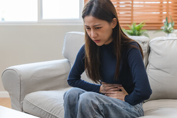 Obraz premium young woman gripping her stomach have abdominal pain .