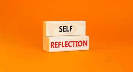 Self reflection symbol. Concept word Self reflection typed on wooden blocks. Beautiful orange table orange background. Business psychological and self reflection concept. Copy space.