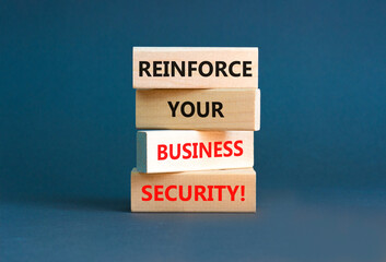 Reinforce your business security symbol. Concept word Reinforce your business security on blocks. Beautiful grey table grey background. Business reinforce your business security concept. Copy space.