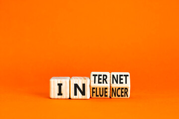 Internet influencer symbol. Concept word Internet influencer on wooden cubes. Beautiful orange table orange background. Business internet influencer concept. Copy space.
