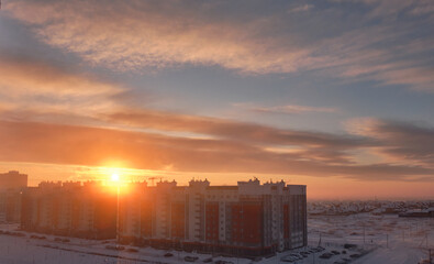 Construction of multi-storey residential buildings at dawn in winter