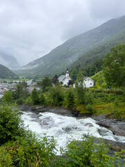 landscape with river,  mountains and an old white church in Norway