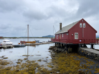 old red house at the shore of the Atlantic ocean with a boat