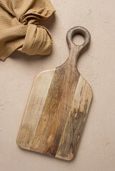 Cutting board, wooden, rectangular shape, with handle, with kitchen towel, top view, no people,