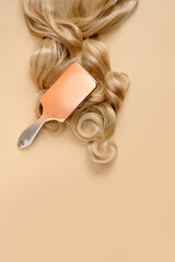 female hair, comb, on a beige background, top view, flat lay. copy space. Self care, hair treatment concept.