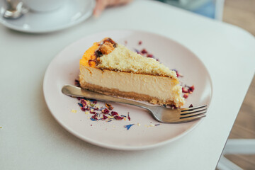 Tasty homemade cheesecake on plate on a table background at city cafe
