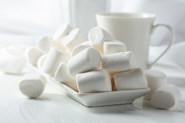 White marshmallows on a wooden table.