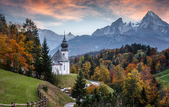 Beautiful nature landscape. Incredible autumn scenery. View on Alpine highlands with Watzmann mount, colorful trees and Small church. Famous Maria Gern Church. Berchtesgaden Bavaria Alps Germany - Powered by Adobe