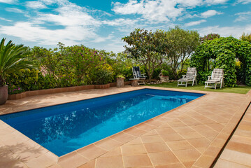 Fototapeta na wymiar Backyard with swimming pool and green lawn