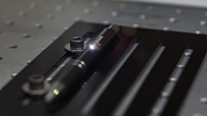 Fototapeta na wymiar Close-up laser engraving action on a black pen
