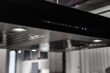 Control panel on a black kitchen hood