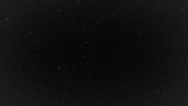 Looped animated texture of white noise on a black background
