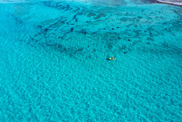 Fototapeta na wymiar Aerial views with drone filming people kayaking off the coast of Europe.