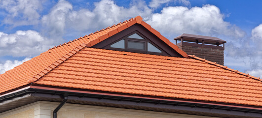 house with a roof from a red shingles with a pipe