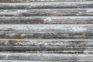 Weathered wooden wall with remnants of white paint remaining in rural Minnesota,
