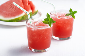 Summer cold drink with watermelon and mint on a wooden background. Copy space
