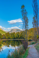 Landscape in the French southern alps in the middle of a large valley in autumn with a lake 