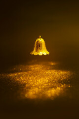 Magic bell and abstract golden material and glittering lights. luxury background for Christmas festival.