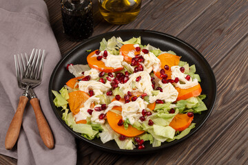 Salad with persimmon, strachatella cream cheese and pomegranate, open space