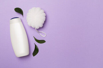 Shower gel with washcloth on color background, top view
