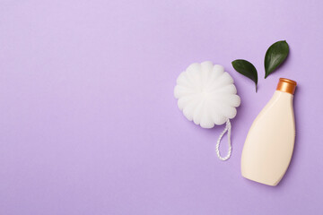 Shower gel with washcloth on color background, top view