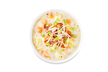 Fresh hot chowder soup with fried bacon slices and shredded cheese in a bowl on a white isolated background