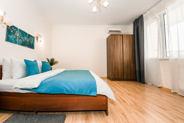 spacious and bright bedroom with a double bed and fresh bedding pillows blankets