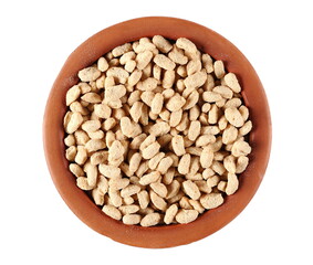 Extruded crunchy oat flakes, pile in clay pot, isolated on white, top view