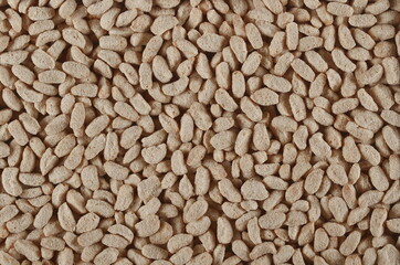 Extruded crunchy oat flakes, pile background and texture, top view