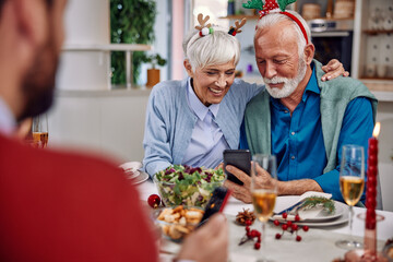 a couple sharing moments on a mobile phone for Christmas