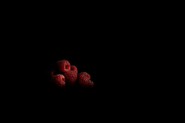 Raspberries on a black background