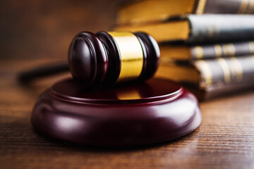 Wooden judge gavel on wooden table.
