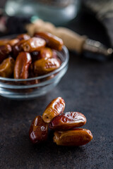 Dried dates fruit on black table.