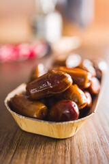 Dried dates fruit on wooden table.