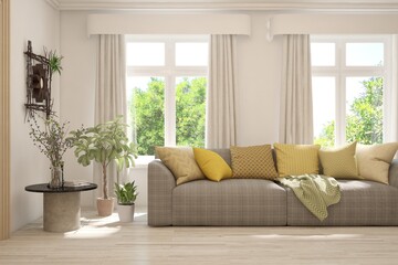Fototapeta premium Minimalist living room in white color with sofa and summer landscape in window. Scandinavian interior design. 3D illustration
